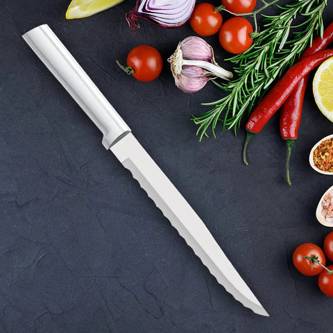 Heavy Duty Serrated Slicer Knife Pair Featuring Wide Double Sided Blades And Deep Teeth That Chews Through Crusty Bread And Tough Produce Without A Sweat Forged From T420 High Carbon Stainless Steel Holds A Razor Sharp Edge on a dark countertop with fresh vegetables.