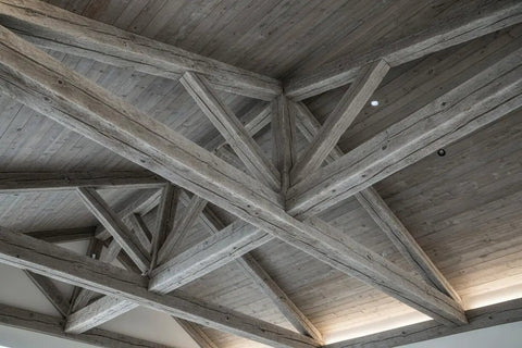 Heritage Gray Reactive Water Based VOC Free Interior Wood Stain 55 Gallon Tank applied to rustic wood beams ceiling.