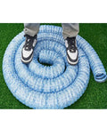 Person standing on coiled Soft Infiltration Perforated Drainage Pipe For Underground Landscaping And Water Management on grass.