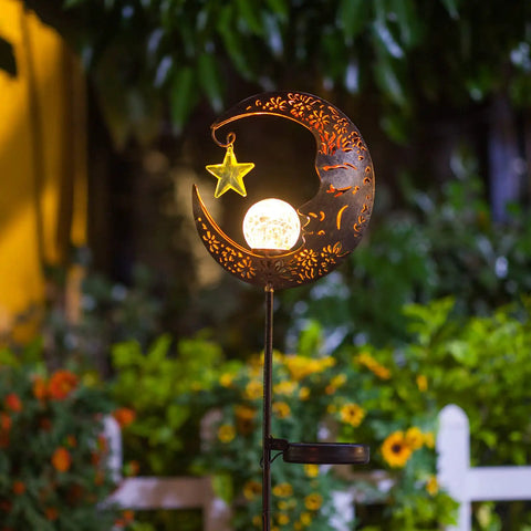 Lit Moonlit Solar Lantern For Outdoor Decor with crackle glass globe, bronze finish, illuminating garden path.