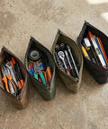Waxed Canvas Tool Pouches 4 Pack, 11-Inch Heavy-Duty Zipper Tool Bags Set with tools and accessories on concrete surface.
