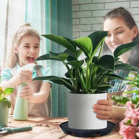 Child and woman caring for plant on Self Watering Pot Base With Automatic Irrigation System For Indoor Outdoor Gardens And Greenhouses Hassle Free Setup Durable PP Plant Tray Waterproof Stand For Pots On Patio Yard Balcony And Farm Pathways