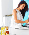 Woman cleaning Custom Fit Gas Stove Top Cover Protector For Your Burner Area - Heat Resistant Up To 572 F - Nonstick Teflon Liner