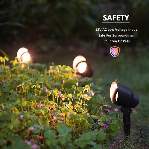 Low Voltage Landscape Spotlight Kit With 20W Halogen Bulbs 12V AC Outdoor Black Lights illuminating garden foliage