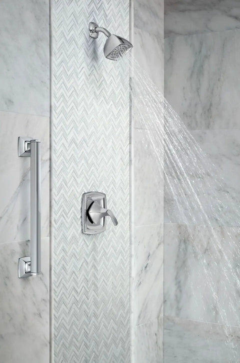 Stainless Steel 24-Inch Bathroom Grab Bar In Brushed Nickel For Safety, ADA Compliant, installed beside a shower in a bathroom.