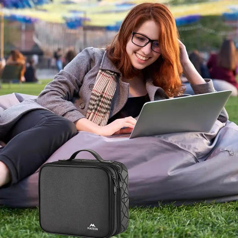 Grab And Go Cable Organizer Bag For Road Trips And Urban Travel Double Layer Electronics Storage Pouch with a woman using a laptop outdoors.