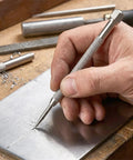 Top Shelf Tungsten Carbide Pocket Scriber For Driving Razor Sharp Weld Marks And Engraving Metal Glass Or Ceramic Sheets With A Comfy Handle That Crushes Rough Work Daily in use on a metal sheet.
