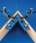 Versatile Adjustable Assembly Square Clamp For Woodworking From 45 To 315 Degrees holding wood boards at an angle on blue surface