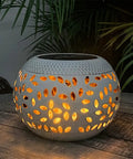 Outdoor Solar Table Lights With Dancing Flickering Flame Dope Style Waterproof White Metal Lantern lit on a wooden table