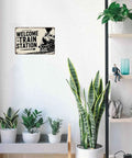 Train Station Steam Locomotive Metal Sign 8x12 Inch Vintage Retro Wall Decor in living room with plants and shelves