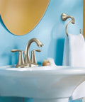 Eva Brushed Nickel Two-Handle 4-Inch Centerset Bathroom Faucet With Drain Assembly installed on a white sink