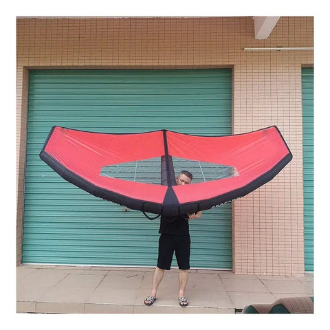Person holding red Handheld Inflatable Surf Wing For Windsurfing And Kiteboarding Do It All Water Sports Wing with TPU bladder