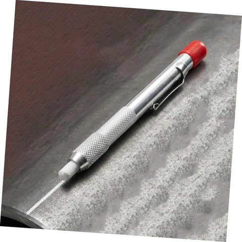 Soapstone Marking Pencil With Aluminum Holder For Welding Supplies laying on a metal surface with chalk marks visible