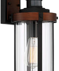 Rock Solid Black Motion Sensor Outdoor Wall Sconce With Zero Fuss Industrial Craftsmanship And Reliable Nighttime Security Lighting For Front Porch Or Driveway, metal fixture with clear glass shade.