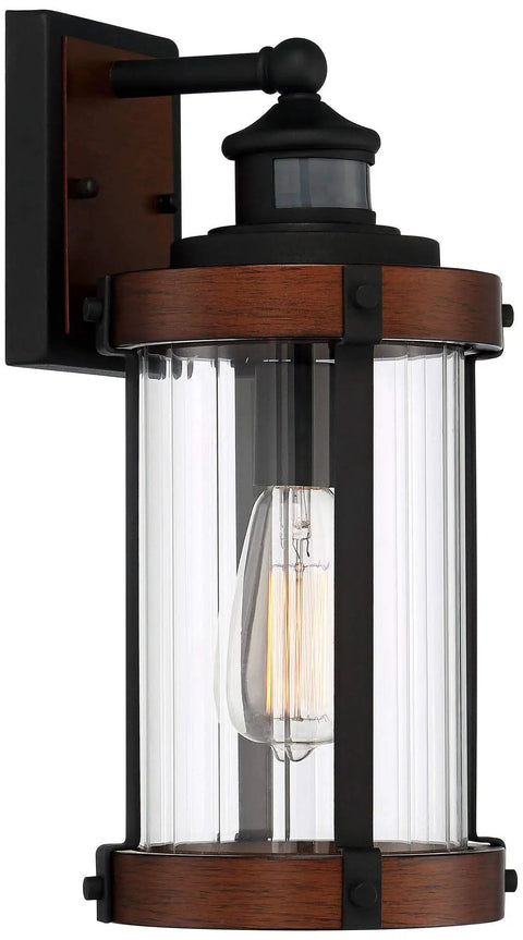 Rock Solid Black Motion Sensor Outdoor Wall Sconce With Zero Fuss Industrial Craftsmanship And Reliable Nighttime Security Lighting For Front Porch Or Driveway, metal fixture with clear glass shade.