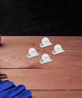 Four Piece Fixed Caster Wheels For Furniture And Cabinets, Durable Non Swivel Polypropylene Rollers on wooden table.