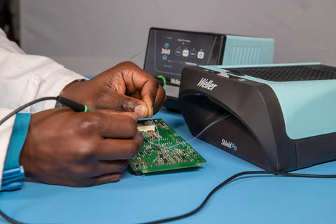 Heavy Duty Soldering Fume Extractor With Beast Mode Adjustable Blower And Top Shelf Particle Control For Single Workbench Setup used during circuit board assembly.