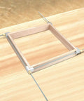 Pro Grade Aluminum Quick Release Corner Framing Clamp Kit For Picture Frames Up To Forty Five And A Half Inches in use on wood frame