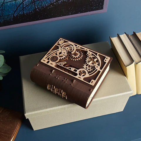 Book Of Secrets Steampunk 3D Puzzle Kit For Adults With Hidden Gears on a desk with other books