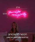 Pink Led Neon Sign Youre Like Really Pretty With Safe Acrylic Backing Large Wall Decor, lit in bedroom with woman underneath