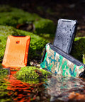 Dark Energy Poseidon Pro Indestructible Portable Charger 10,000 mAh Black With USB A And USB C Connectors on moss in nature