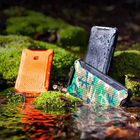 Dark Energy Poseidon Pro Indestructible Portable Charger 10,000 mAh Black With USB A And USB C Connectors on moss in nature