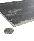 Close-up of Retro Nero Porcelain Floor And Wall Tile 8.25 X 23.5 Inches showing texture and thickness next to a coin for scale.