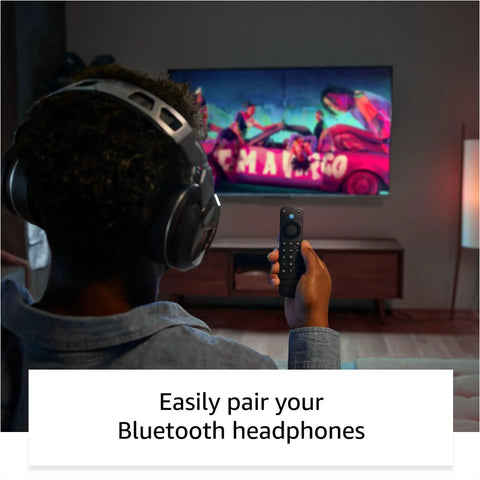 Man using Alexa Voice Remote Pro For Fire TV With Remote Finder Backlit Buttons TV Controls Volume And Power Hands Free Newest Model