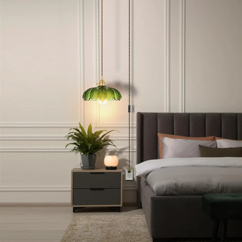 Chic Green Glass Swag Lamp With Inline Switch Plug In Pendant Fixture For Kitchen Island Bedroom Dining And Living Room Cozy Vintage Floral Hanging Decor in a cozy bedroom setting.