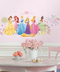 Disney Princess Glow Peel And Stick Wall Decals Kit Featuring 36 Vinyl Stickers in bright multicolor on a playroom wall.