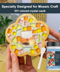 Hand holding glass mosaic art with jar of white quick dry crystal tile grout ready to use caulking agent for crafts