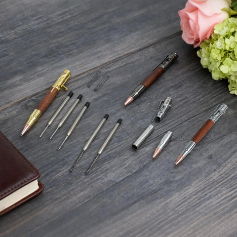 Bolt Action Pen Kit Set With Mandrel For Woodturning 9 Pcs DIY Ballpoint Pen Making Kit In Silver Gold And Gun Gray With Rosewood Bushings And Black Refills Go To DIY Gift For Men displayed on wooden surface.