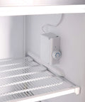 A Top Shelf 3 Cubic Foot Midi Upright Freezer In Stainless Steel With Reversible Door And Adjustable Feet For Basements Or Break Rooms This Sweet Space Saver Delivers Zero Fuss Setup And Drops Heavy Chill Wherever You Park It Today interior view showcasing adjustable shelves and temperature control.