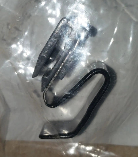 Close-up of Mitsubishi MR970563 Fuel Filler Door Release Cable Clip Genuine OEM Part showing metal structure