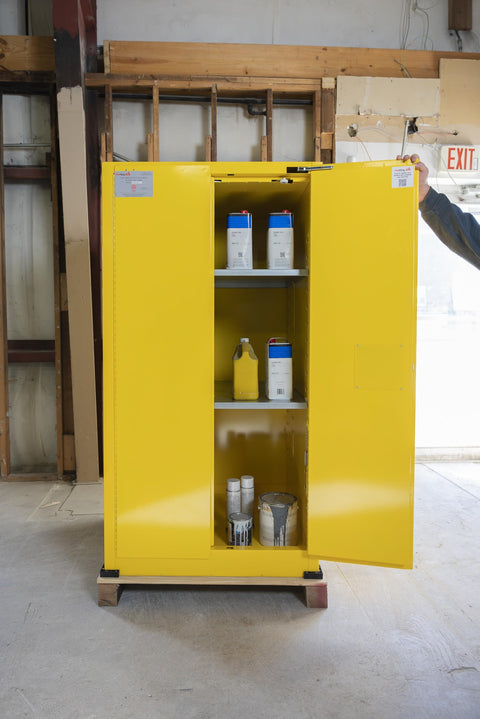 Heavy Duty 60 Gallon Flammable Safety Cabinet With Automatic Door displaying yellow storage with paint cans inside.
