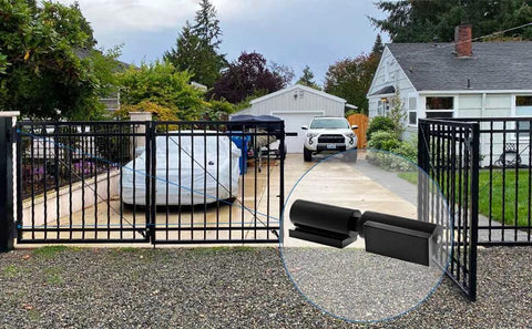 Heavy Duty 7 Inch Gate Hinges 2 Pack Black Iron Barrel Style Weld On For Swing Gates Trailer Ramp Gates And Doors 900 Lb Capacity Durable Cold Rolled Steel Hinge Set For High Load Applications installed on a driveway gate.