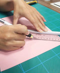 Using 45mm Rotary Cutter And Precision Knife Set For Art Quilting And Crafting With 12 Bonus Blades on pink paper
