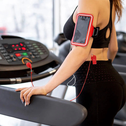 Person using treadmill with Two Pack Treadmill Magnetic Safety Keys Universal Round Emergency Stop Switch Replacement attached to clothing.