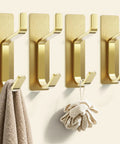 Ditch the Drill with These Heavy Duty Adhesive Towel Hooks for Bathroom 4 Pack Stainless Steel Wall Mounts, gold finish with towel and mesh sponge.