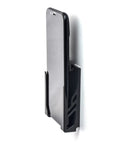 Legit Sturdy Black Smartphone Mount With Heavy Duty Screw Or Tape Options For Vehicles And Home Desk No Sweat Setup and Broad Compatibility For Daily Commutes And Office Use sitting next to a black smartphone.