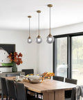 Dining room with smoked glass globe pendant light brushed gold finish for kitchen island and dining room dope modern mid century brass hanging fixture