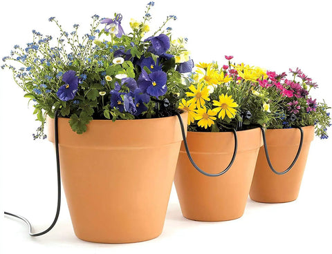 Terracotta pots with flowers and No Fuss Drip Watering System With Timer For Containers And Hanging Baskets, black tubing visible.