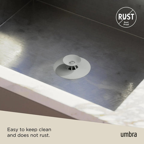 Dual Purpose Silicone Shower Drain Stopper And Hair Catcher Kills Sticky Pipe Buildup in sleek grey tone on stainless steel sink.