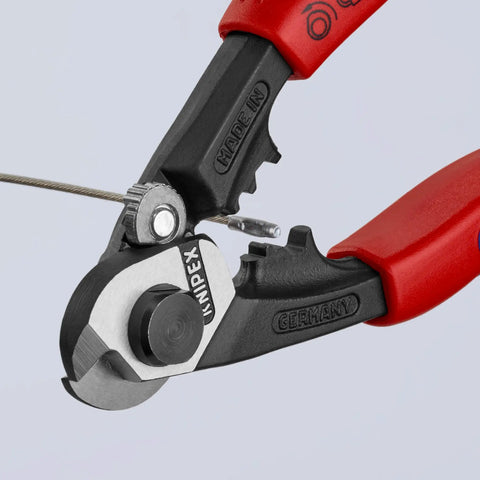 Close-up of Heavy Duty Wire Rope Cutter And Crimping Tool With Comfort Grip Pro Grade cutting a wire rope, showing cutting mechanism.