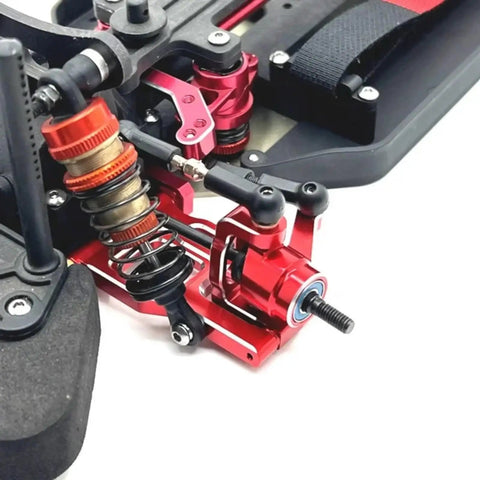Close-up of Heavy Duty Metal Front And Rear Suspension Arm Steering Cup Hub Carrier Set For 10th Scale RC Cars Compatible With PTG2 Platform Rad Beefy Upgrade Kit In Bright Red.