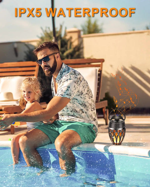 Man by pool with 2 Pack Outdoor Bluetooth Speakers With LED Flame Flickers, IP5X Waterproof Lantern Speakers For Patio Yard Pool Party nearby