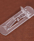 Close-up of a single transparent shelf peg from 30 Pieces Plastic Shelf Pegs For Cabinets And Shelves Self Locking Clips For 15mm To 16mm Wood Boards