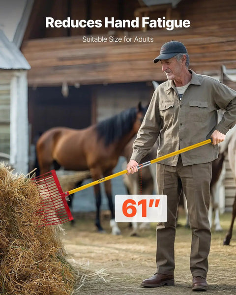 Man using 61 inch Manure Fork with 18 angled tines and fiberglass handle for stable cleanup with horses in background.