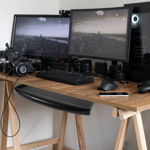 Undermount Keyboard Tray With Ergonomic Tilt And Clip Mount installed on a wooden desk below dual monitors for efficient workspace organization.