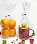 Flat Bottom Cellophane Bags 7x3x12 Inches Clear Treat Bags For Cookies, 100 Pieces With Twist Ties, Filled with Oranges and Chocolates